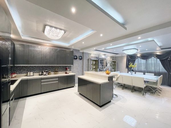 Sleek and dramatic: Merlgen’s smoky grey kitchen cabinets in high gloss