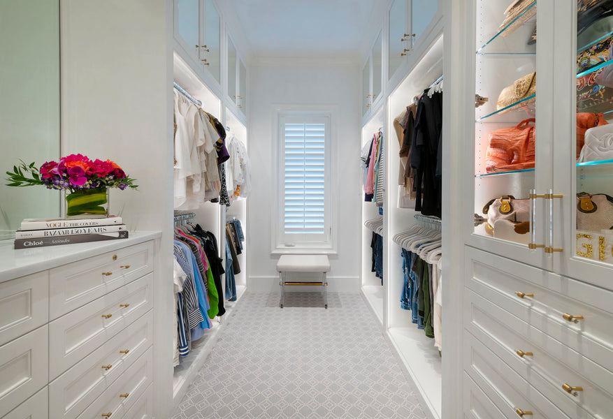 Bright white closet with automated wardrobe lifts